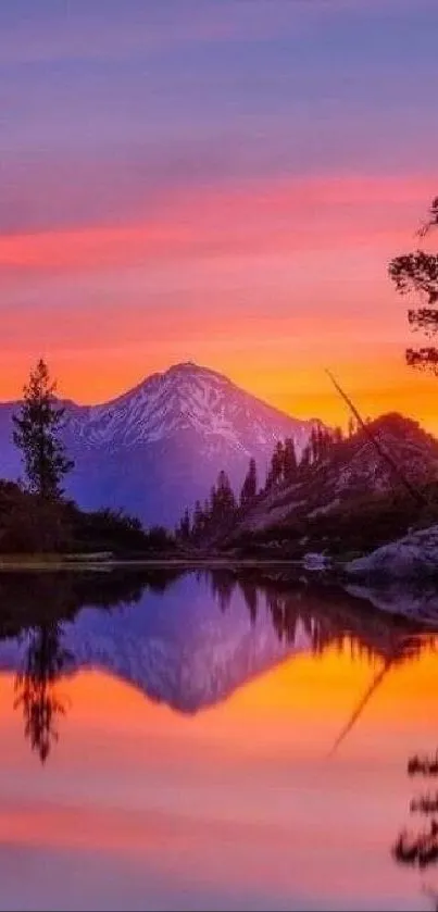 Vibrant sunset over mountain reflecting in calm lake.