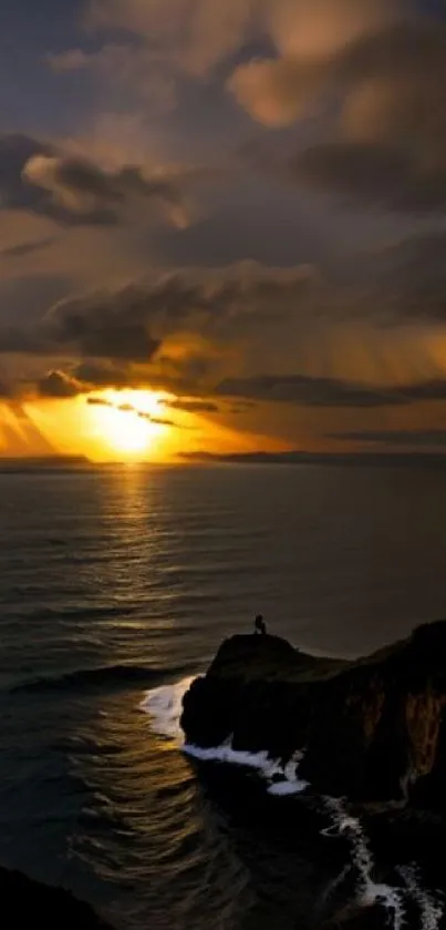 Sunset over an ocean with clouds and cliffs in warm, golden hues.