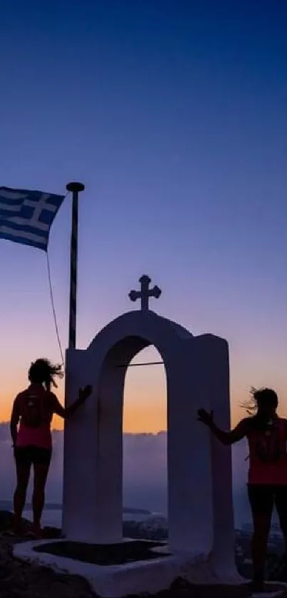 Silhouetted figures and a Greek flag against a sunset backdrop.