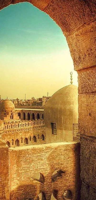 A picturesque golden sunset over historic architecture with a bird in flight.