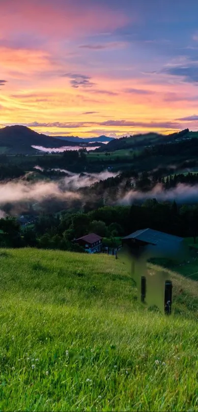 A breathtaking sunset with misty hills and lush green landscape.