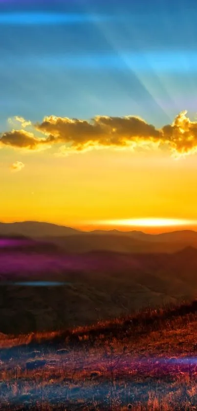 Vibrant sunset over a mountainous landscape with colorful sky.