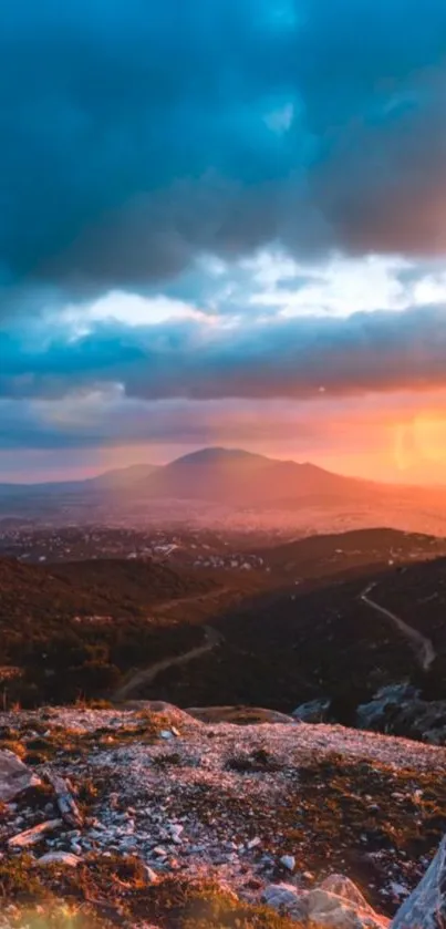 Scenic sunset over a mountain landscape with vibrant orange hues.