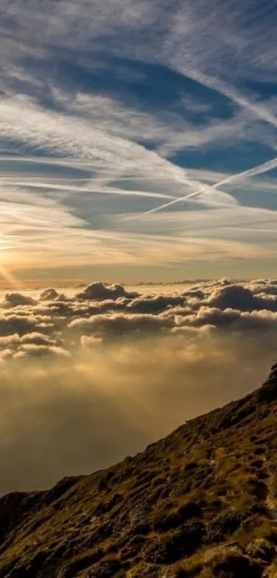 Sunset over mountain peaks with clouds and sun rays.