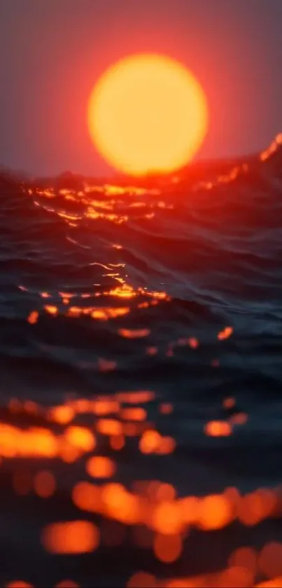 Sunset over ocean waves with orange and blue colors.