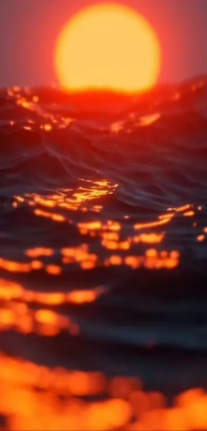 Bright orange sunset over ocean waves with glowing reflections.