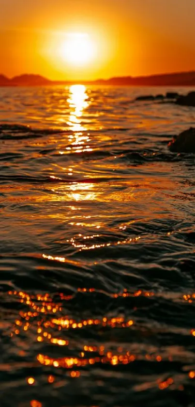 Sunset casting golden hues over ocean waves.