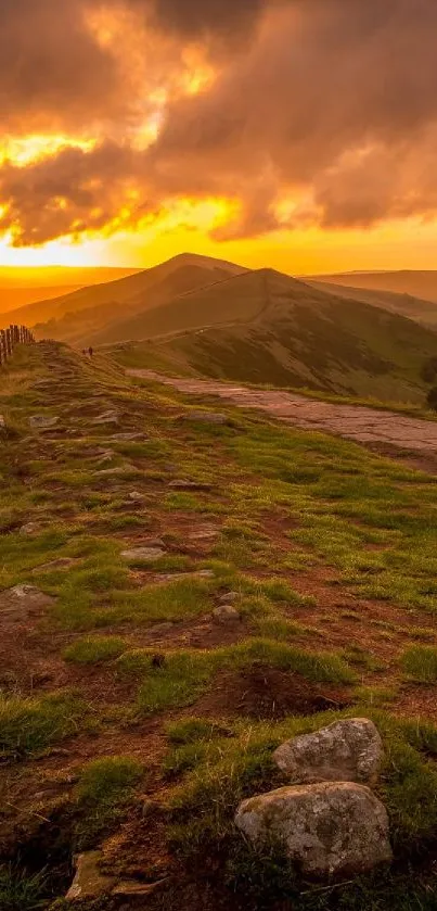 Sunset over green hills with dramatic skies.