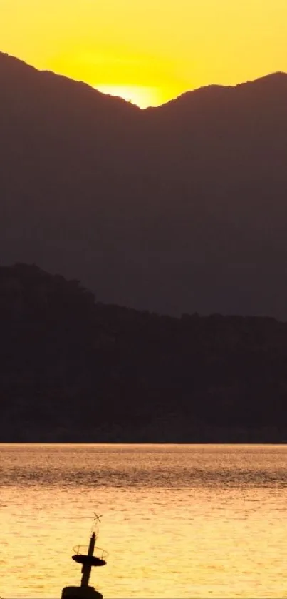 Orange sunset over a serene mountain lake scene.