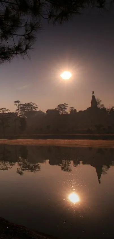 Sunset reflecting over a tranquil lake with silhouetted trees.