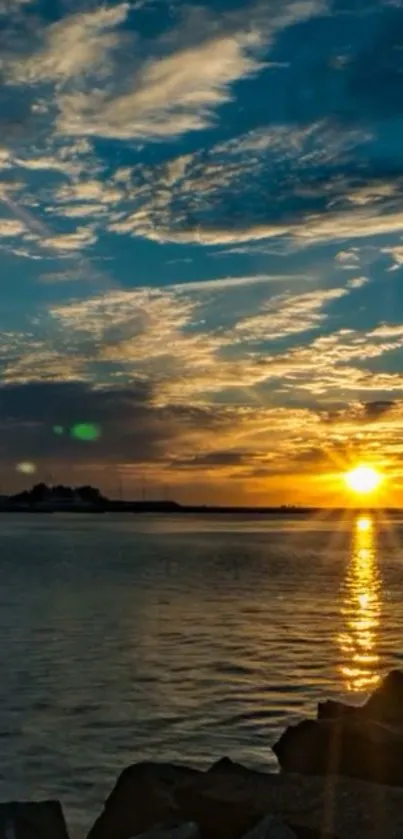 Stunning sunset over blue waters and clouds with golden reflections.