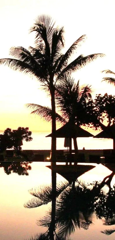 Silhouetted palm trees against a peach sunset.