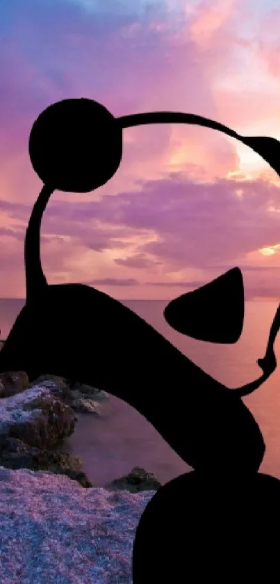 Panda silhouette on beach at sunset with vibrant sky.