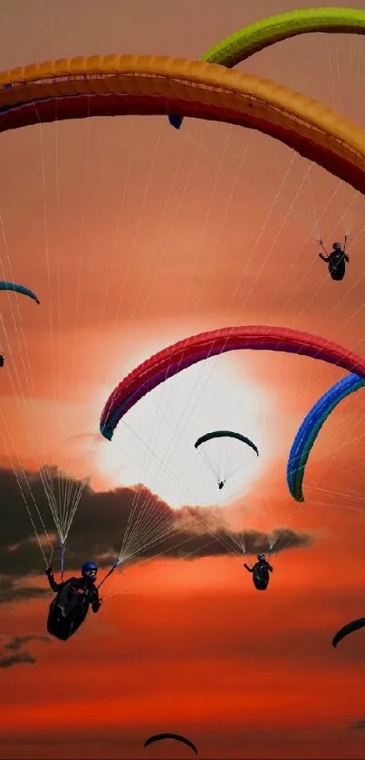 Paragliders soaring in sunset sky with vibrant colors.