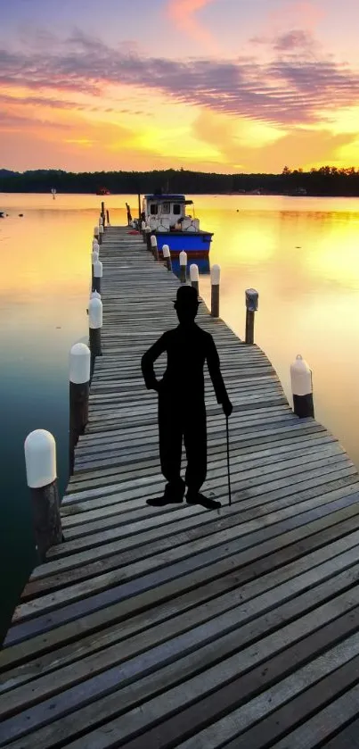 Silhouette on a pier with sunset hues reflecting on water.