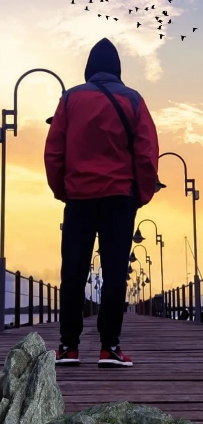 Silhouetted figure on a pier at sunset with a dramatic sky.