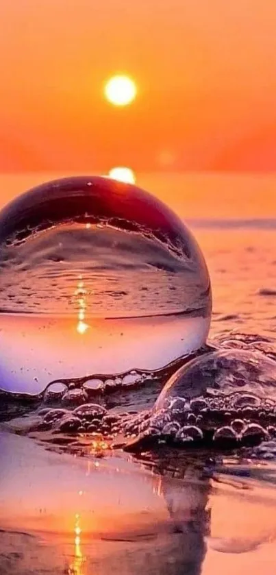 Sunset reflecting in a glass sphere on the ocean shore, creating a serene wallpaper.