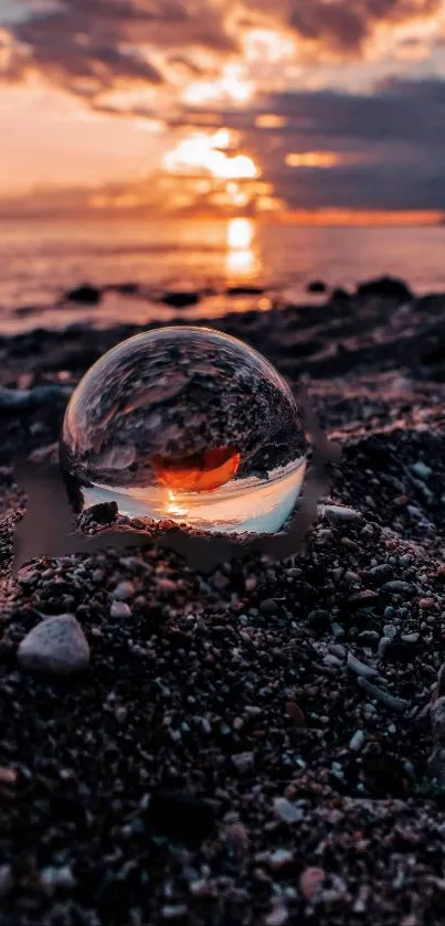 Glass sphere reflects a stunning sunset on the beach.