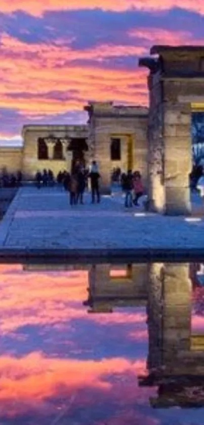 Sunset reflection at ancient temple with vibrant sky and serene water.