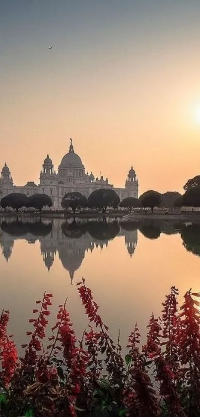 Sunset reflecting a palace over calm waters with garden in the foreground.