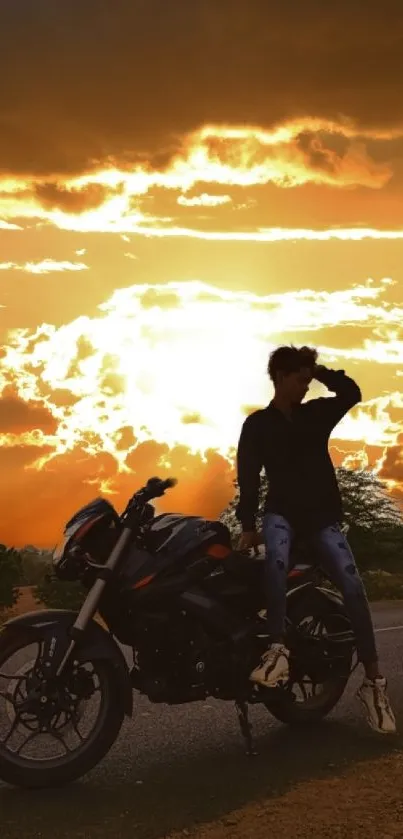 Silhouette of biker with motorcycle against a vibrant sunset sky.