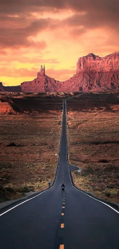 Sunset road leading to red mountains in the desert.