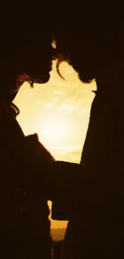Silhouette of a couple sharing an intimate moment against a glowing sunset backdrop.