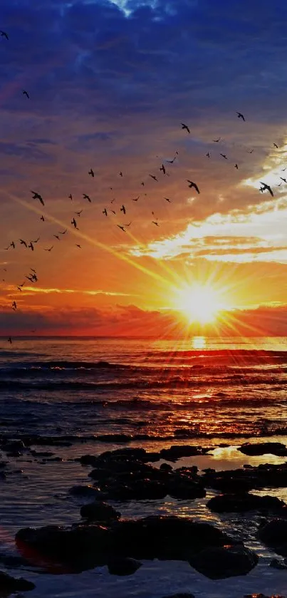 Vibrant sunset over ocean with birds soaring in the colorful sky, creating a serene view.