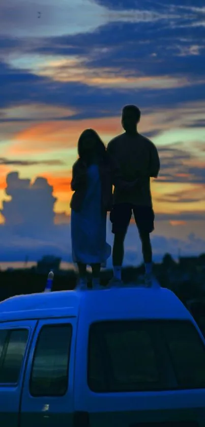 Silhouette of people on a van roof at sunset with vibrant sky hues.