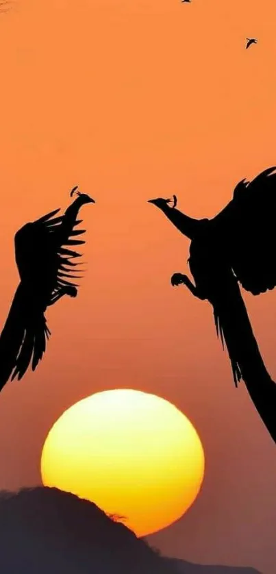 Silhouetted birds against orange sunset sky, creating a serene and elegant landscape.