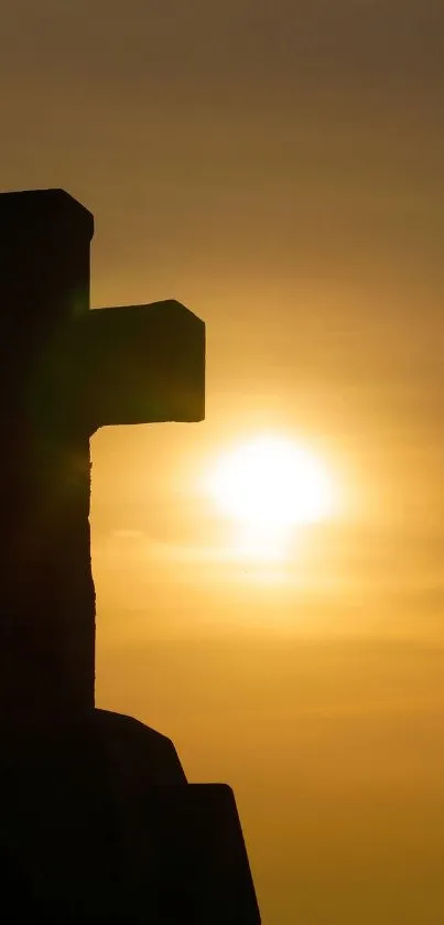 Silhouette of a cross against a golden sunset sky, exuding tranquility.