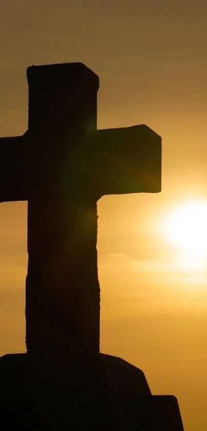 Silhouette of a cross against a golden sunset backdrop.