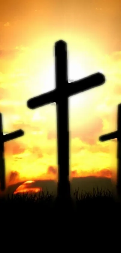 Three crosses silhouetted against a glowing sunset sky.