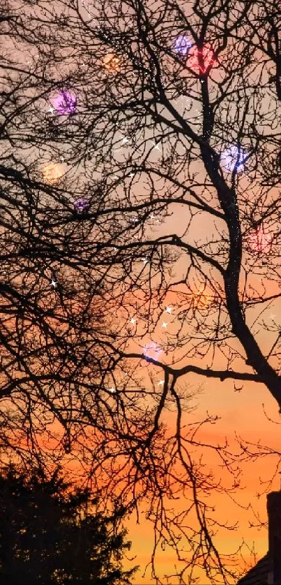 Silhouetted trees against an orange sunset sky with a house in view.