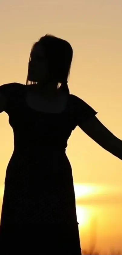 Silhouette of a woman against a golden sunset sky on mobile wallpaper.