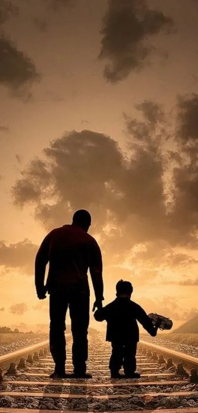 Father and child walking along a railway track at sunset.