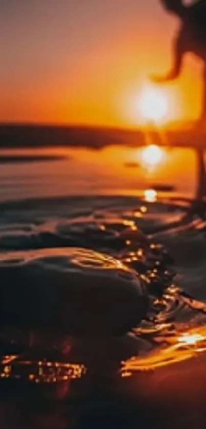 Serene silhouette at sunset over water with orange glow.