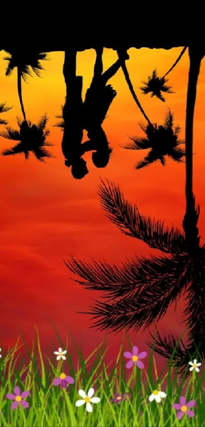 Silhouette of couple at sunset with palm trees and vibrant red-orange sky.