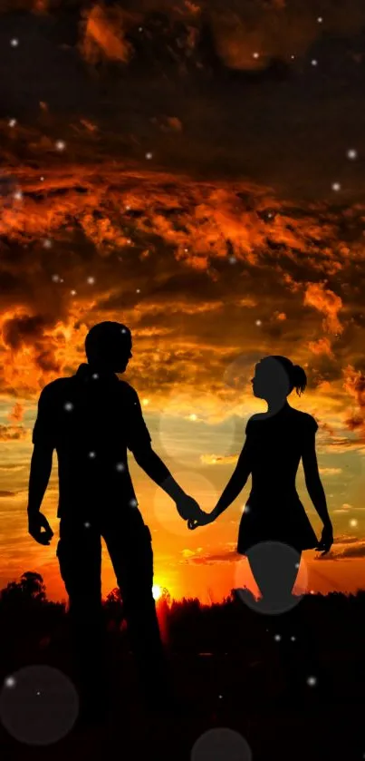 Silhouette of a couple holding hands at sunset with a dramatic sky.