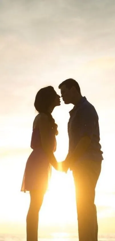 Romantic couple silhouette at sunset by the ocean.