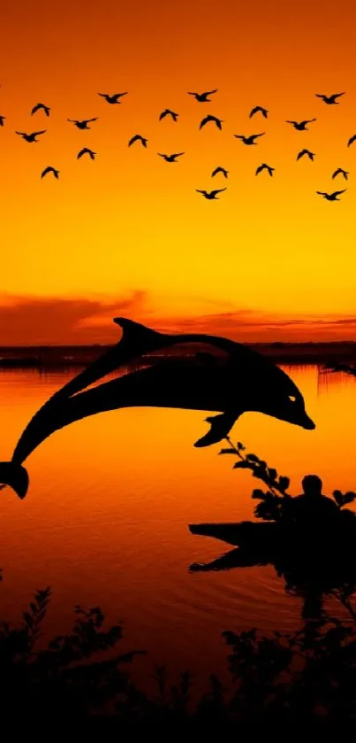 Orange sunset with dolphins and silhouette reflection on water.