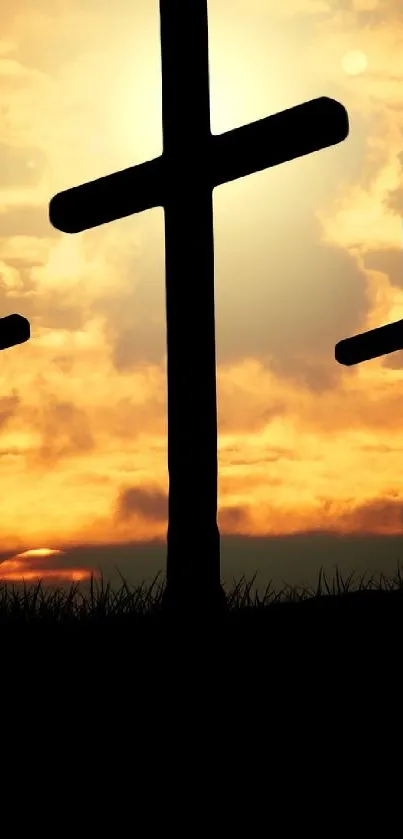 Silhouette of three crosses against a vibrant sunset sky.