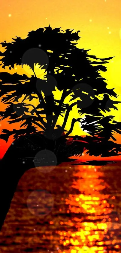 Silhouette of a tree against a vibrant sunset over the ocean.