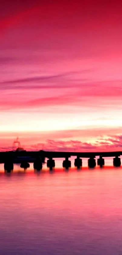 Silhouette on a dock with a vibrant pink sunset.