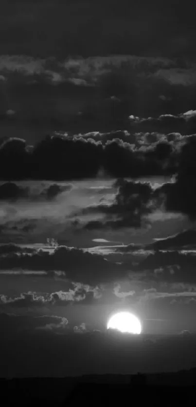 Dramatic sunset with red clouds and dark silhouette of landscape.