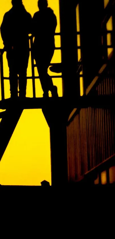 Silhouette of figures on stairs against a bright yellow sunset backdrop.