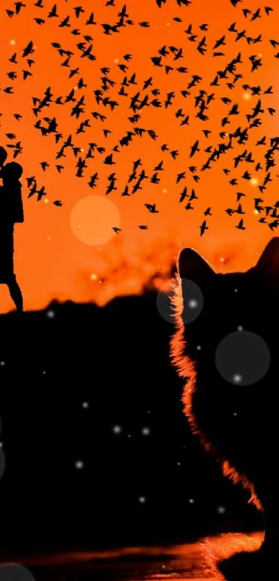 Silhouette of a cat set against a vibrant orange sunset scene.