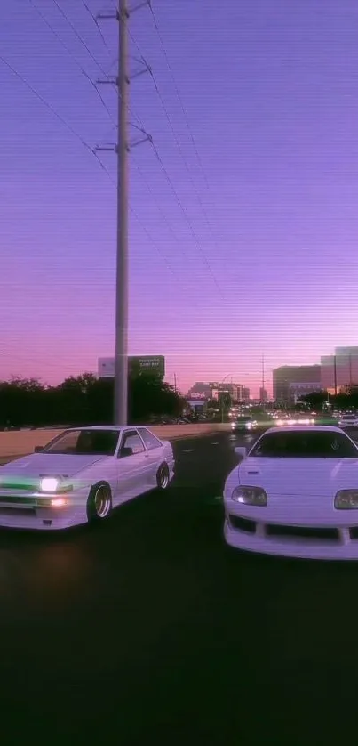 Two white sports cars under a violet sunset sky on a busy urban street.