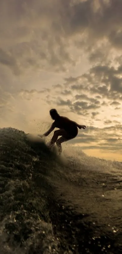 Silhouette of a surfer riding a wave against a dramatic sunset sky.