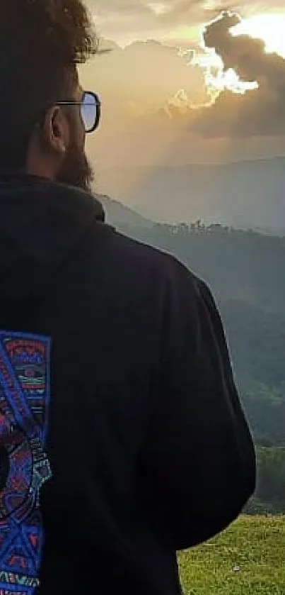 Silhouette view standing on terrace during sunset over mountains.